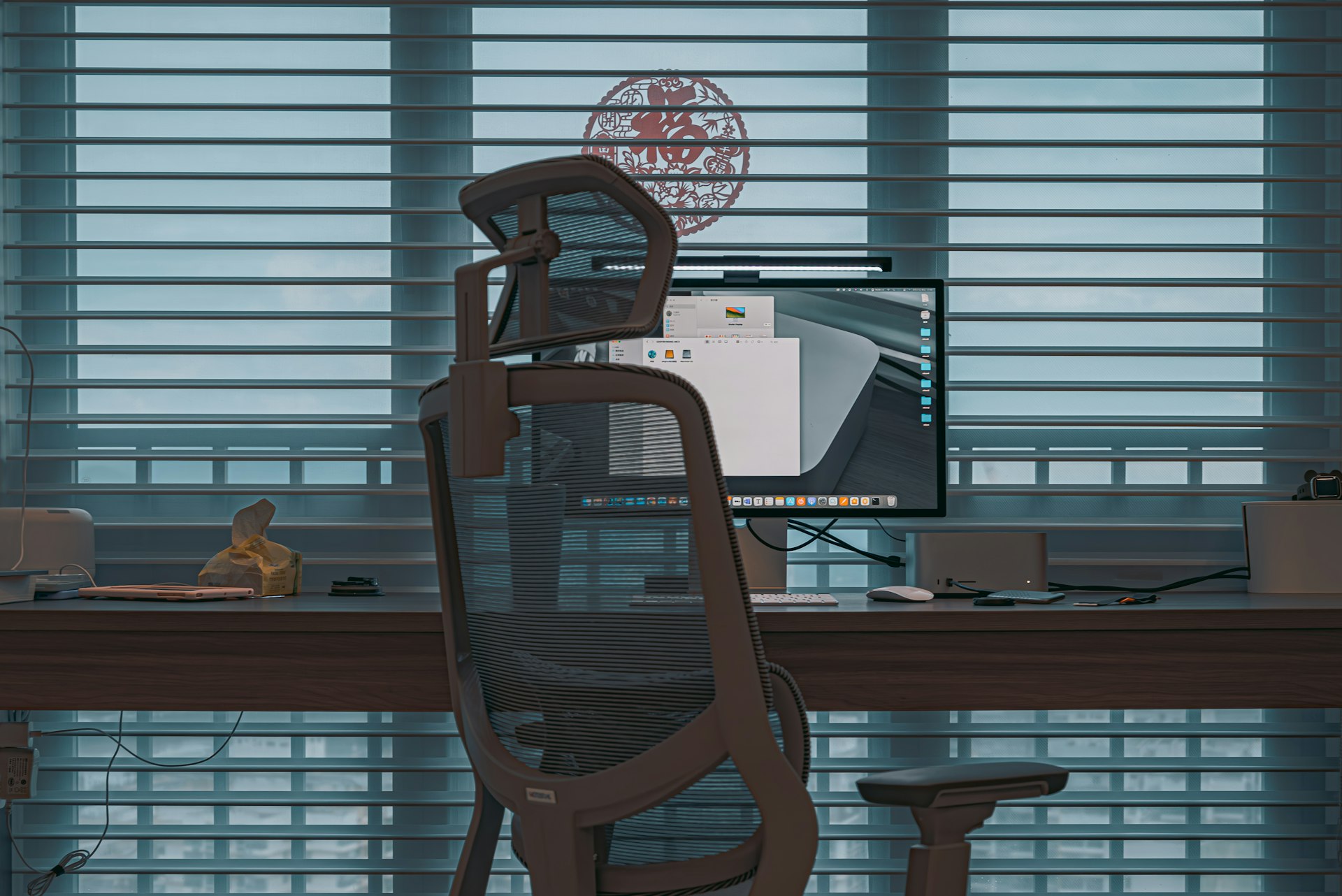 a computer desk with a monitor and a chair